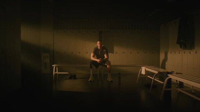 Adaptive Athlete in Dressing Room, Taking Deep Breath and Focusing Mind. Mans Powerful Look at Lens Conveys Confidence, Courage, Unbreakable Human Spirit. Mental Preparation for Challenge. Portrait.