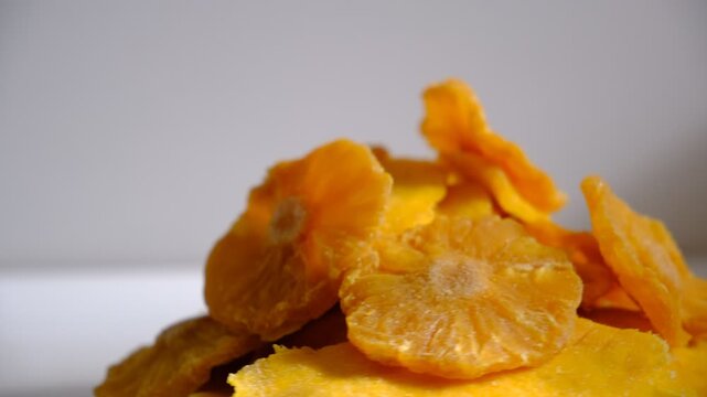 Dried tropical fruits pineapples, papaya, mango rotation in circle on a white background.