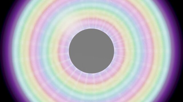 Colorful light patterns form expanding circles around a central point