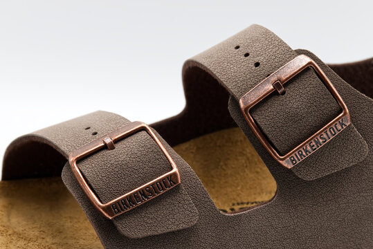 Bologna - Italy - June 21, 2026: Close up of brown birkenstock sandals milano with bronze buckles and textured straps on white background.