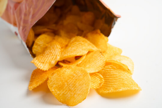 Potato chips, delicious BBQ seasoning spicy for crips, thin slice deep fried snack fast food in open bag.