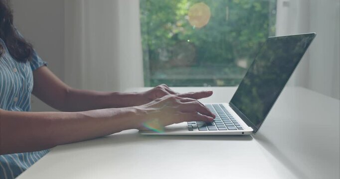 Close up. Hand of middle woman using laptop at home office natural light	