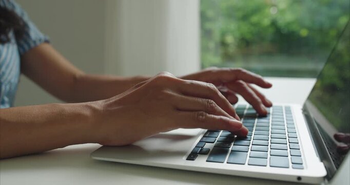 Close up. Hand of middle woman using laptop at home office natural light