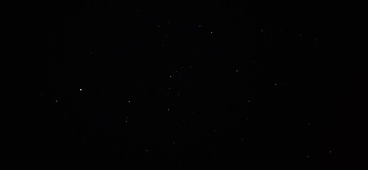 Minimalist starry night sky background, deep black space with subtle white stars, cosmic night sky texture for cinematic overlays and astronomical designs © khalil