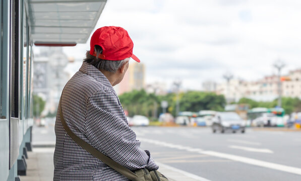 A lonely senior woman sadly Sitting by the roadside