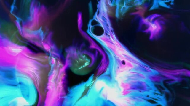 The movement of neon-colored ink or liquids mixing together. A combination of electric blue, pink, purple, and a touch of turquoise green moves slowly and dynamically against a dark background.