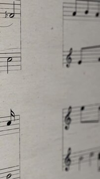 Macro view of a tied musical note over staff lines with an a tempo marking, refined precise mood, ideal for music education tutorials and creative media.
