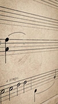 Close-up of eighth notes and dynamics on aged beige sheet music in warm soft light, nostalgic artistic mood, suited for music heritage and creative projects.