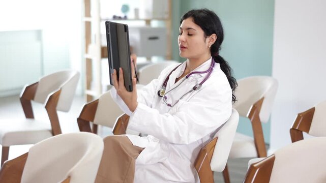 Female medical student point tablet camera at widescreen slide presentation screen, take photos, or scan QR ode to follow link. Photographing lecture educational material from screen