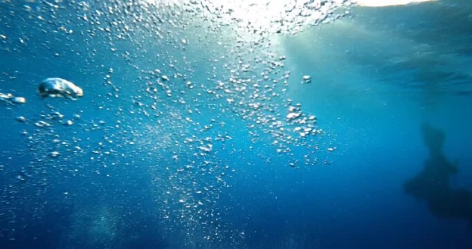 Underwater Bubbles Rising to Sunlight Surface.