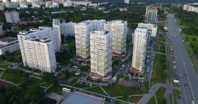 Aerial shot of a green residential district in Zelenograd under dark dramatic clouds with visible rain approaching in the distance
