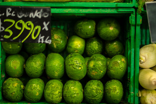 Green zapallito courgettes displaying market price in grocery store