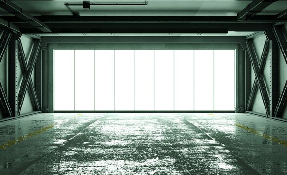 Dark, wet floor interior of a massive industrial hangar
