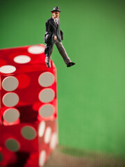 Naklejka premium Conceptual shot of a miniature businessman figurine stepping off a