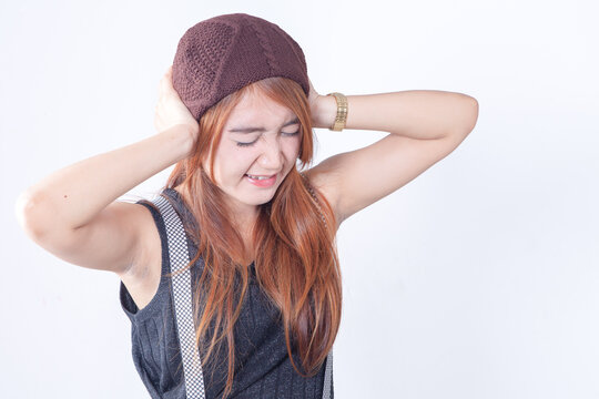 Stressed Young Asian Woman Covering Her Ears from Loud Noise