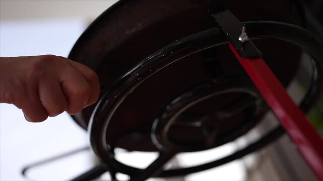 Hand with a lighter igniting a camping gas stove