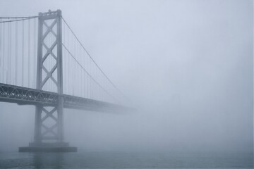 Fototapeta premium Foggy Bay Bridge Suspension Tower and Cables in San Francisco