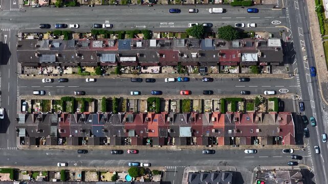 Static aerial view of Victorian terraced houses and residential streets in Beeston Leeds West Yorkshire UK showing rooftops parked vehicles urban housing density and neighbourhood infrastructure