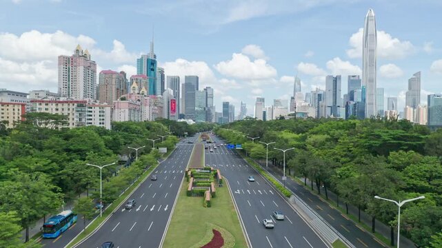 Shenzhen China skyline above a tree-lined boulevard with modern skyscrapers
