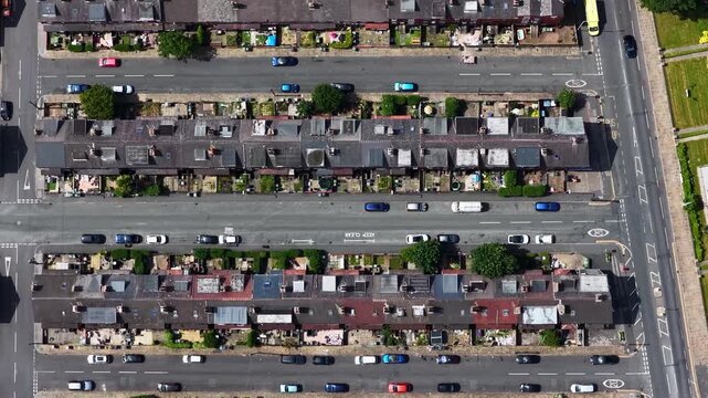 Aerial drone view of Victorian terraced houses and residential streets in Beeston Leeds West Yorkshire UK showing rooftops parked vehicles urban housing density and neighbourhood infrastructure