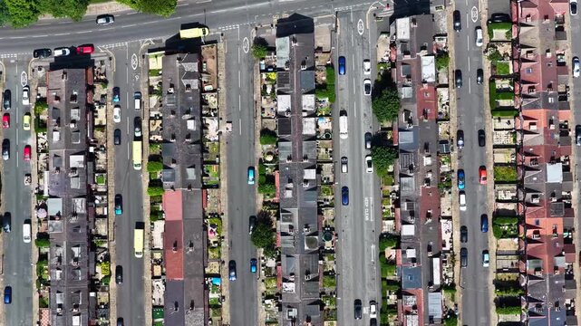Aerial view of Victorian terraced housing in Beeston Leeds West Yorkshire showing residential streets parked vehicles back gardens urban density and neighbourhood layout from above during summer