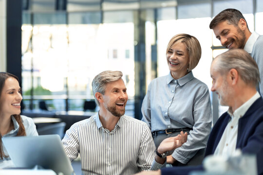 Business team discussing together business plans in office.