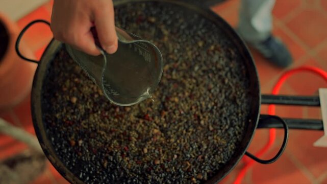 Chef cooking spanish black rice paella