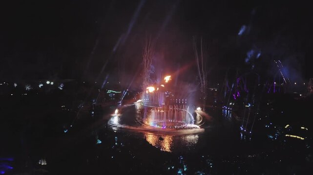 Illuminated Night Fountain and Laser Show Over Water