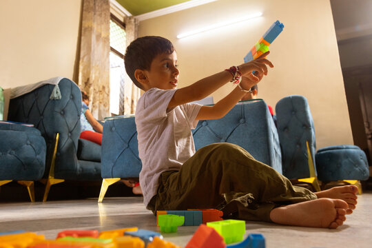 Boy playing with blocks in living room
