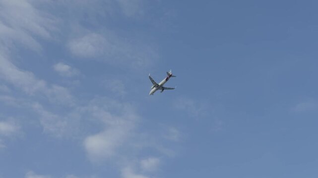 Commercial Passenger Airplane Flying In Clear Blue Sky. Jet Aircraft Airliner Soaring In Atmosphere. Aviation Transport