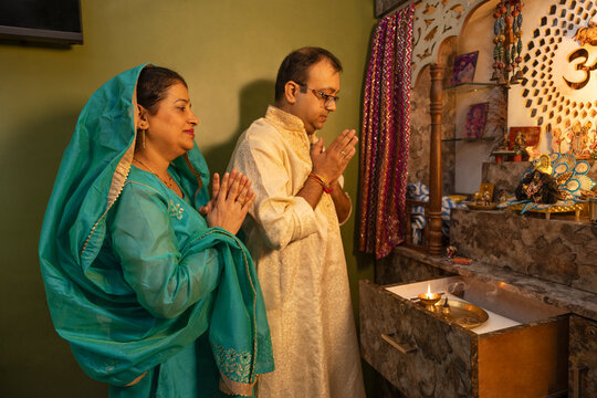 Couple engaged in a prayer ritual at home