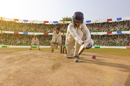 Female cricketer executing a sweep shot