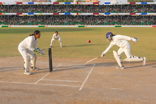 Batsman diving to make the crease in a cricket match
