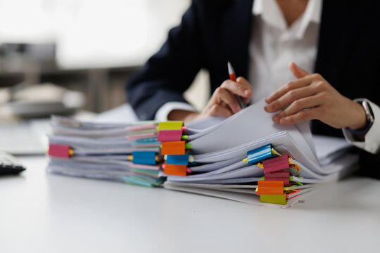 Serious professional businesswoman in office working with Documents, Business, accountant Documents documents at her desk in a modern office environment
