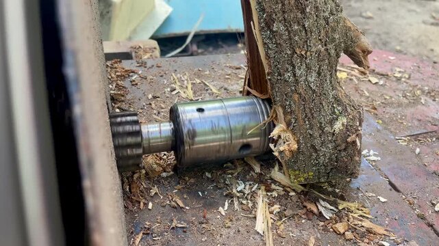 Cone wood splitter drilling and splitting a log, close up