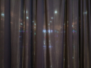 Obraz premium Black fabric curtain texture background with soft light shining through. Elegant folded dark drape panel abstract backdrop for interior design, theater, or stage concept.
