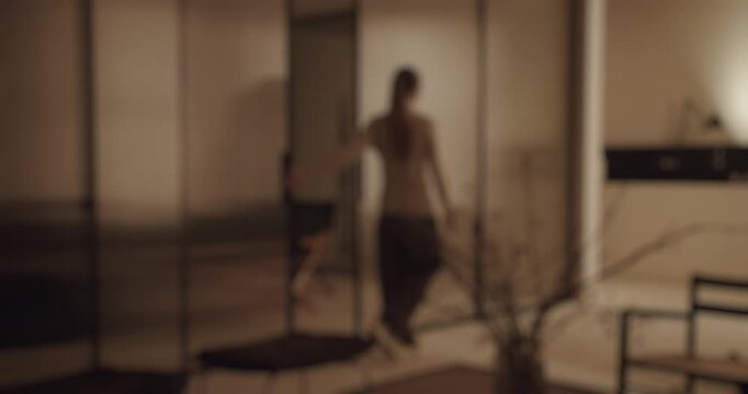 Disoriented woman walking slowly with anxiety through her stylish apartment, feeling a sense of loneliness and isolation, a powerful visual representation of psychological distress