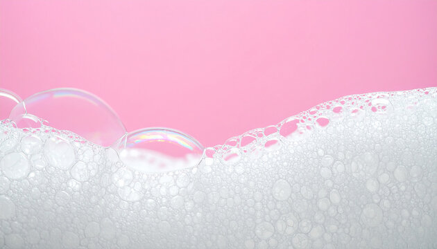White soap foam and shampoo bubbles against pink background. Refreshing hygiene and bath care concept. Pure freshness. Close-up.