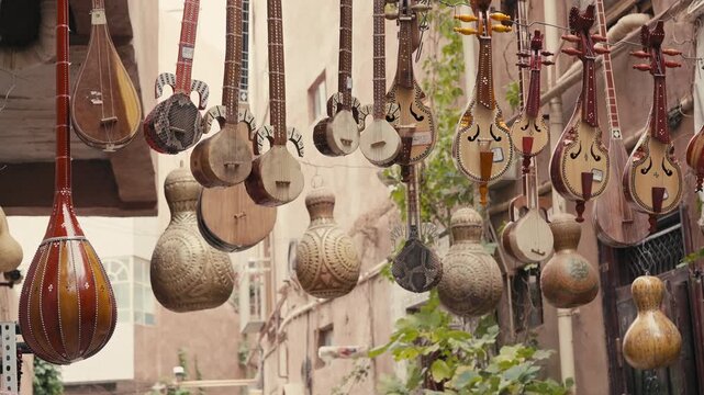 Traditional string instruments hanging in an old street market