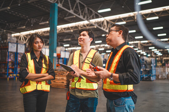 Warehouse manager talking and using digital tablet while checking product in warehouse, Logistic industry concept.