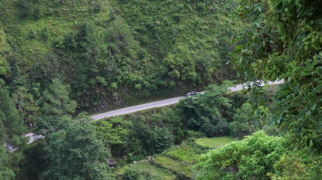 Cinematic Road Trip Footage: Vehicle Navigating a Remote Highway in the Mountains