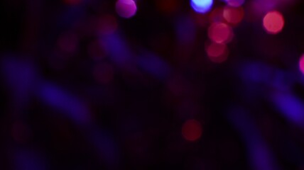 Abstract colorful bokeh lights with vibrant glowing spots and blurred dark background © M Halim Abduh