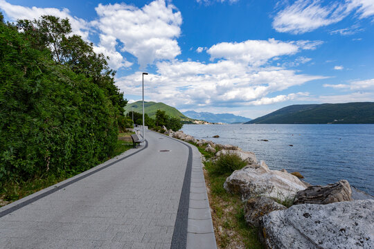Seaside promenade of Herceg Novi curving beautifully along the deep blue waters of the Bay of Kotor, Montenegro