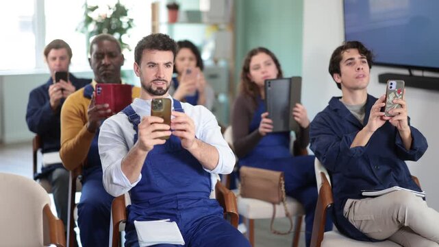 Staff workers take photos of presentation slide or scan QR code. Lecture on changes in labor legislation, trade union meeting, mandatory professional development