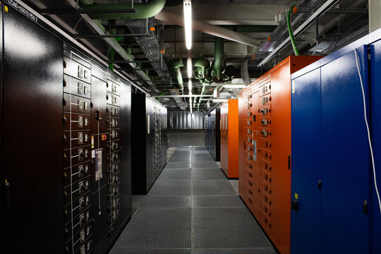 Lugano, Switzerland - 18 March 2026: View of the Swiss National Supercomputing Centre featuring rows of colorful server cabinets and industrial infrastructure.