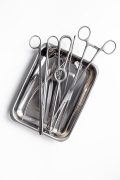 Sterile surgical instruments and tools - scalpels, scissors and others - in a stainless tray, top view