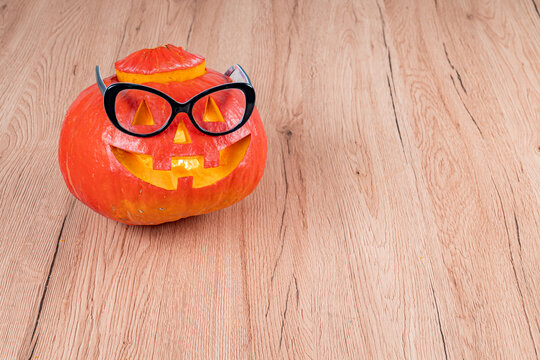 Smart jack o' lantern wearing glasses celebrating Halloween