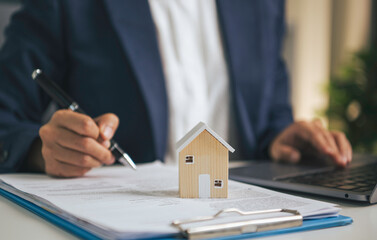 Home insurance and mortgage documentation concept with house model property protection planning real estate financing contract approval and residential investment management © Custard Pixel