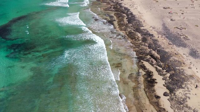 Aerial Flyover above  Famara Beach Cliffs and Coastal Village in Northwest Lanzarote