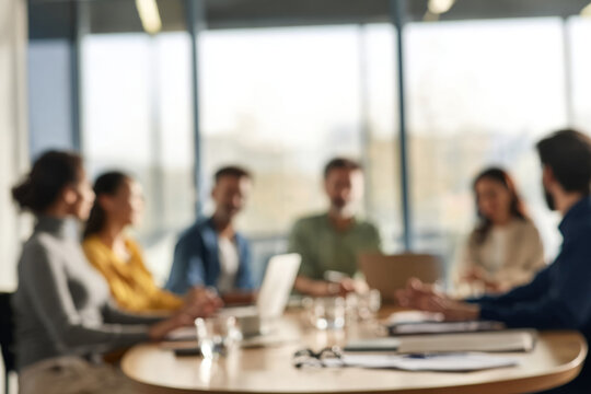 Blurred business meeting with a diverse team collaborating in a modern corporate office conference room, fostering strategic discussion and dynamic teamwork in a bright workspace.